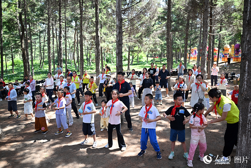 2026年5月31日，在吉林長春動植物公園，吉林大學白求恩第二醫(yī)院的醫(yī)護家庭參加了一場親子活動。孩子們在現(xiàn)場跟隨老師學習八段錦。人民網(wǎng)記者 李成偉攝